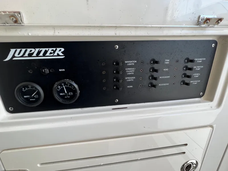 Slide: The Image of Control panel of a 2013 Jupiter 30 FS boat with gauges and switches. - 33