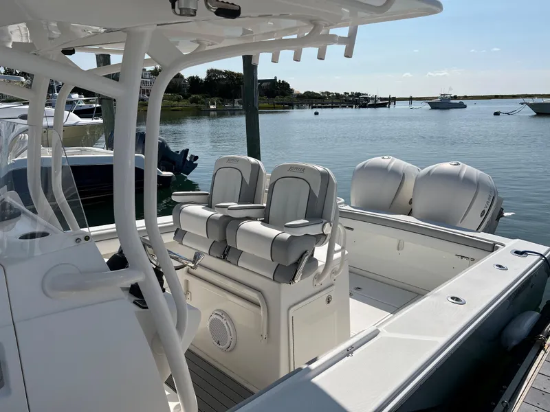 Slide: The Image of 2013 Jupiter 30 FS boat with dual engines docked in a serene marina. - 38