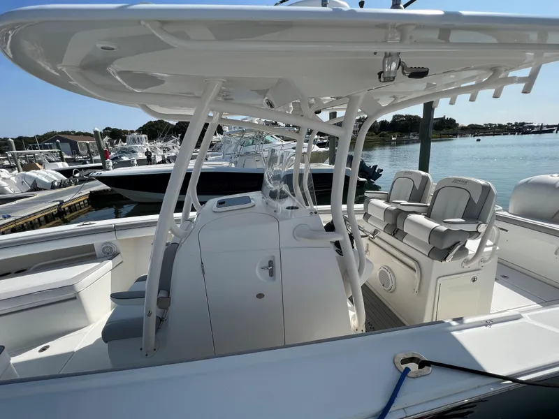 Slide: The Image of 2013 Jupiter 30 FS boat with sleek design, spacious seating, and modern amenities docked by the water. - 39