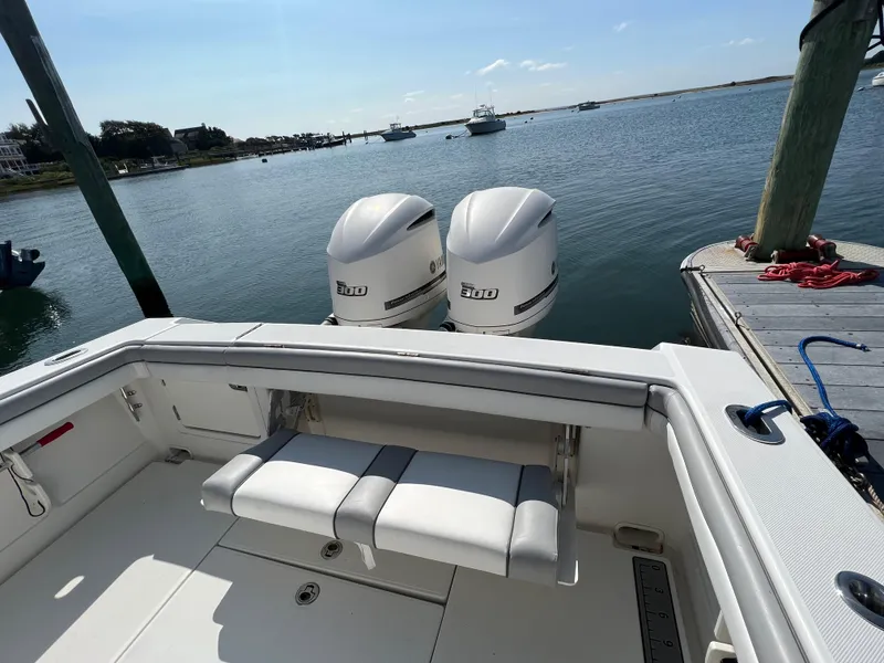 Slide: The Image of 2013 Jupiter 30 FS boat with twin engines docked by the water. - 4