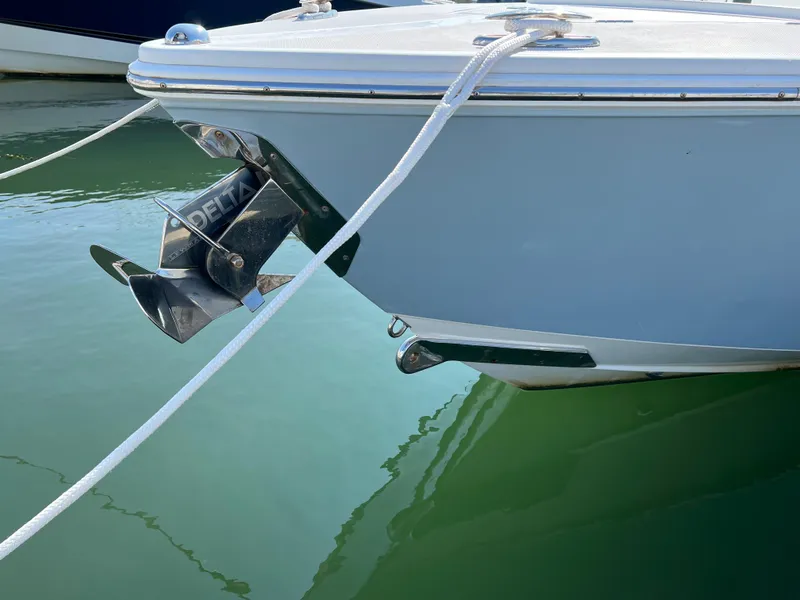 Slide: The Image of 2013 Jupiter 30 FS boat anchored in calm water, showcasing its sleek bow design. - 40