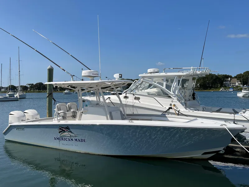 Slide: The Image of 2013 Jupiter 30 FS boat docked in a marina under clear blue skies. - 5