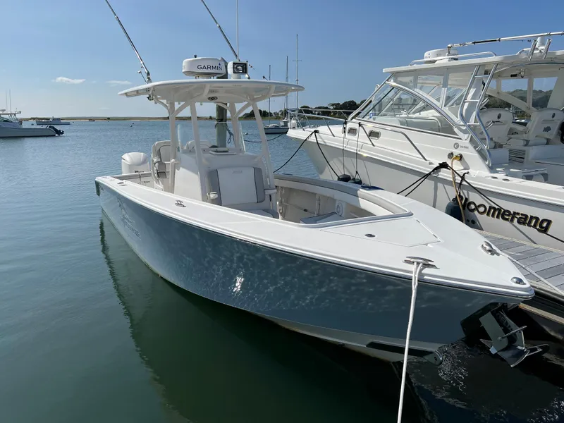Slide: The Image of 2013 Jupiter 30 FS boat docked in a marina under clear blue skies. - 6