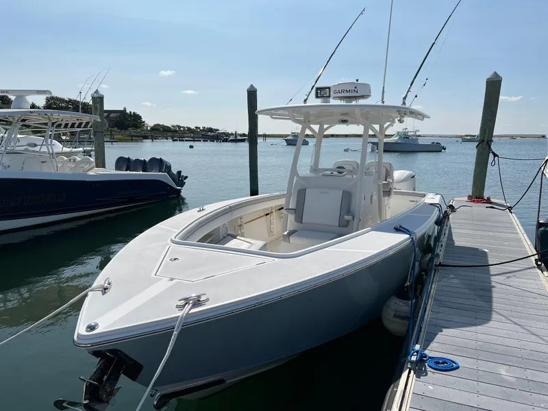 Slide: The Image of 2013 Jupiter 30 FS boat docked in a marina under clear skies. - 7