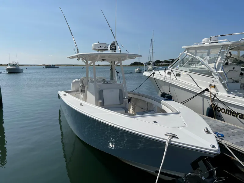 Slide: The Image of 2013 Jupiter 30 FS boat docked in a marina under clear blue skies. - 8
