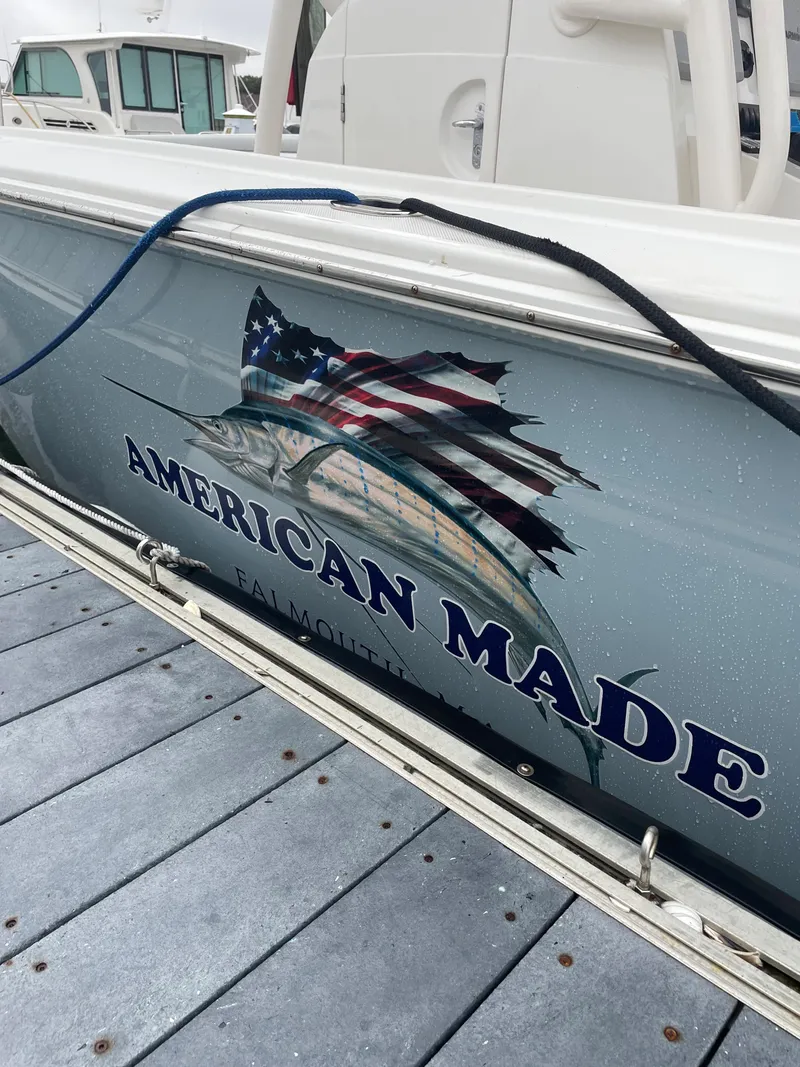 Slide: The Image of 2013 Jupiter 30 FS boat with "American Made" and flag graphic on the side. - 9