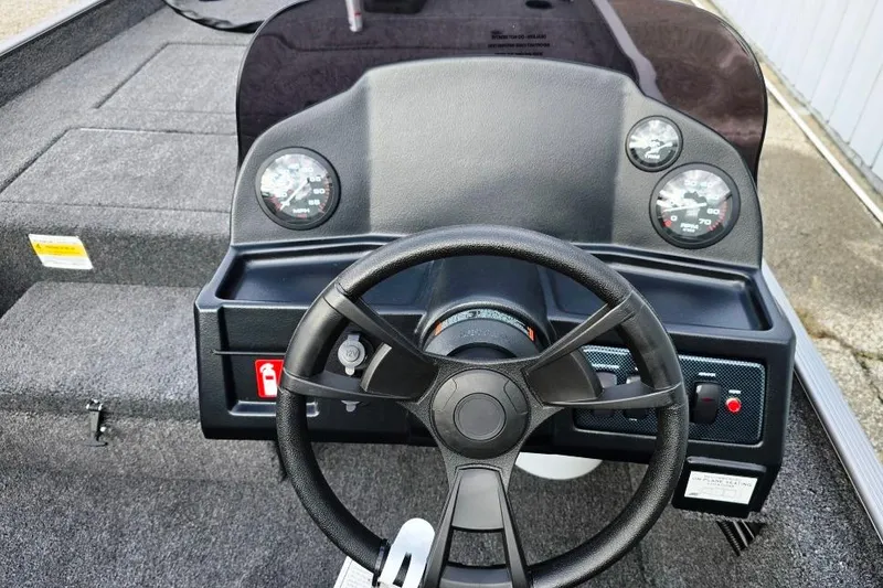 Slide: The Image of 2026 Lowe Skorpion 17 boat with outboard motor, parked outdoors on a sunny day. - 10