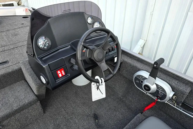 Slide: The Image of 2026 Lowe Skorpion 17 boat interior with steering wheel and control panel. - 3