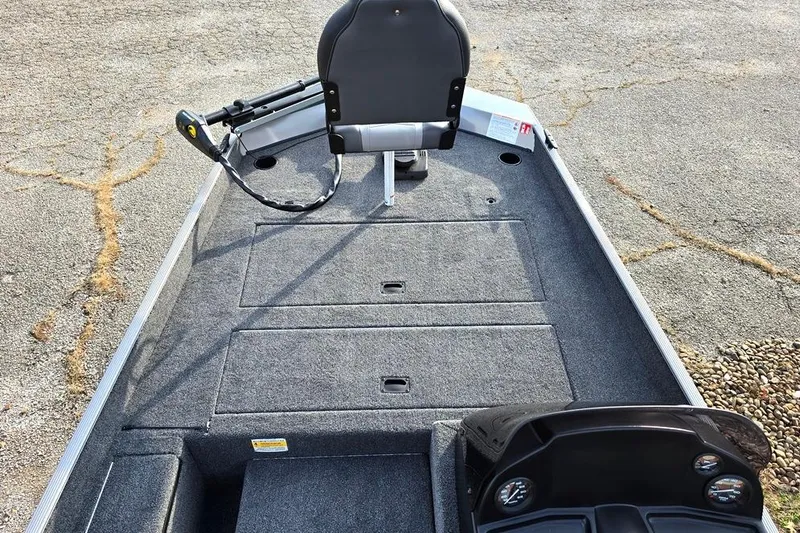 Slide: The Image of 2026 Lowe Skorpion 17 boat interior with steering console and seating. - 4