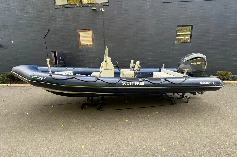 Slide: The Image of 2019 Ribcraft 7.8 inflatable boat with Yamaha engine, parked on pavement. - 0