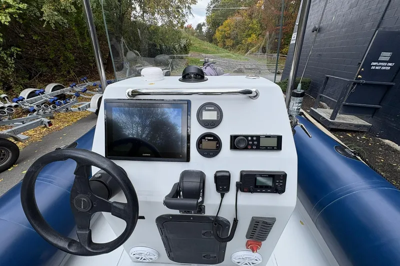 Slide: The Image of Ribcraft 7.8 boat dashboard with steering wheel and navigation instruments, 2019 model. - 1