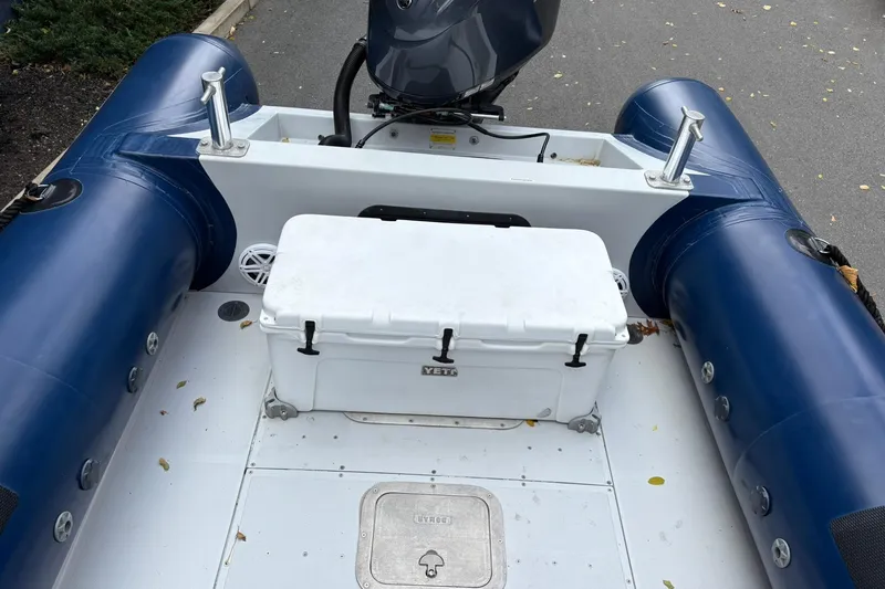 Slide: The Image of Ribcraft 7.8 boat interior with Yeti cooler, 2019 model, featuring blue inflatable tubes. - 11