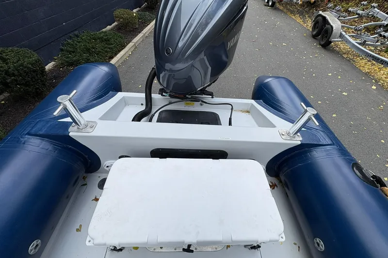 Slide: The Image of 2019 Ribcraft 7.8 inflatable boat with Yamaha outboard motor, docked on a paved area. - 14