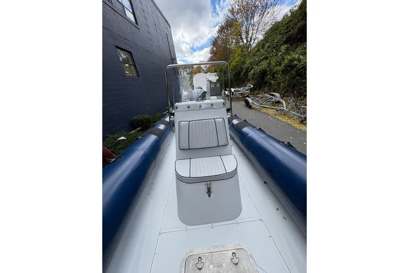 Slide: The Image of 2019 Ribcraft 7.8 boat with blue inflatable tubes, docked outdoors. - 16