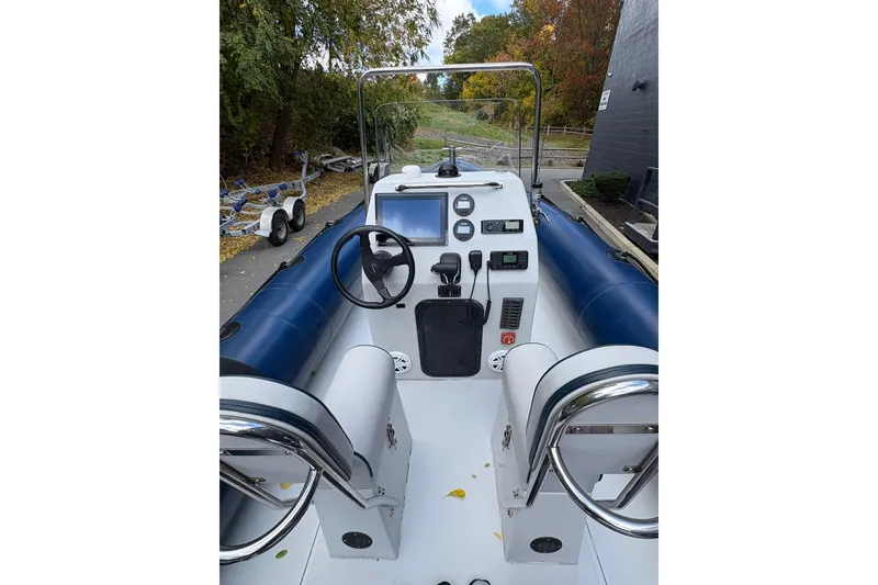Slide: The Image of 2019 Ribcraft 7.8 boat cockpit with steering wheel, controls, and seating. - 4