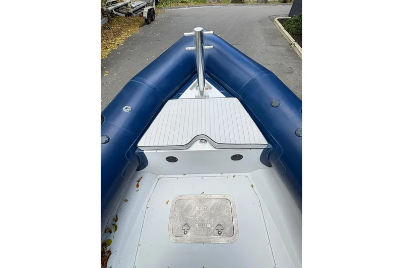 Slide: The Image of 2019 Ribcraft 7.8 inflatable boat, blue and white deck, docked on pavement. - 5