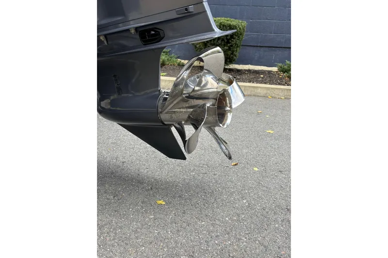 Slide: The Image of Close-up of a Ribcraft 7.8 boat propeller, 2019 model, on a paved surface. - 8