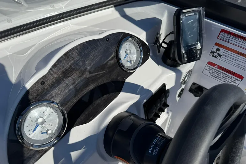 Slide: The Image of Dashboard of 2026 Stingray 191 DC boat with gauges and Garmin device. - 14