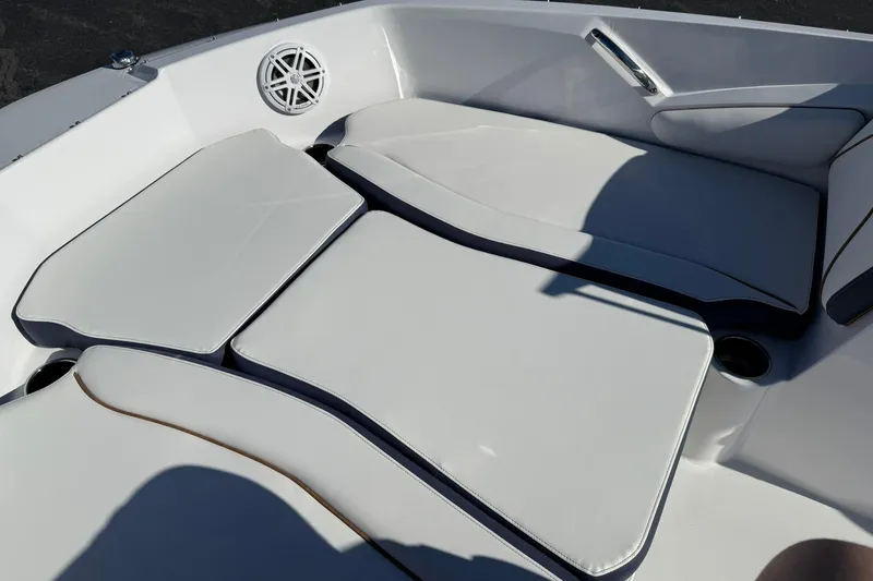 Slide: The Image of 2026 Stingray 191 DC boat interior with white cushioned seating and speaker. - 15