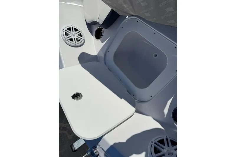Slide: The Image of 2026 Stingray 191 DC boat interior with speakers and storage compartment. - 16