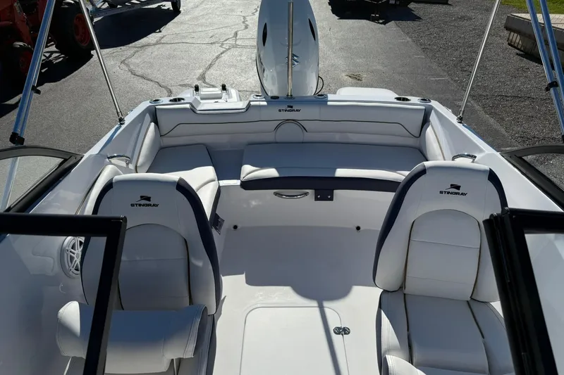 Slide: The Image of 2026 Stingray 191 DC boat interior with white seating and sleek design. - 17