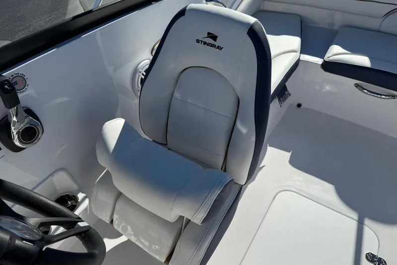 Slide: The Image of 2026 Stingray 191 DC boat interior with white seating and control panel. - 19