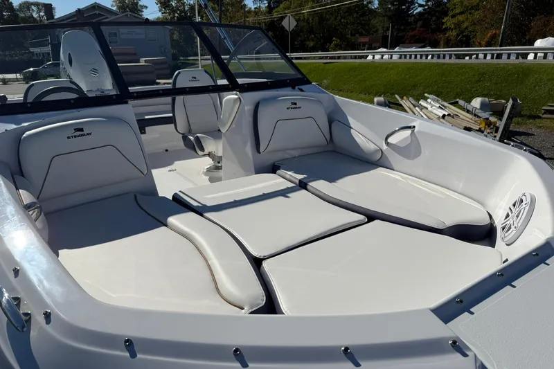 Slide: The Image of 2026 Stingray 191 DC boat interior with white cushioned seating and sleek design. - 7