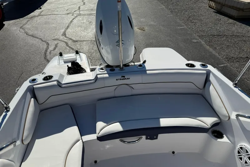 Slide: The Image of 2026 Stingray 191 DC boat interior with white seating and cup holders. - 8