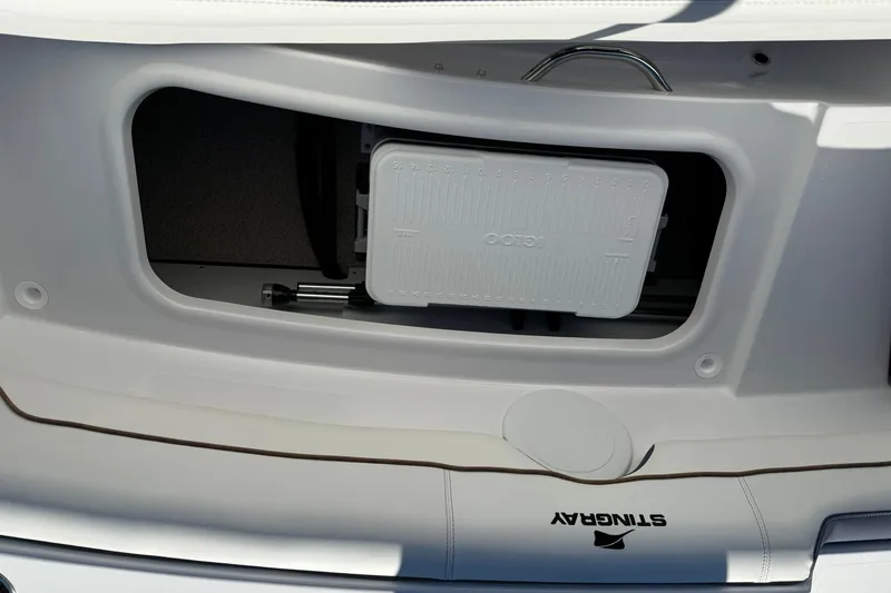 Slide: The Image of Storage compartment in 2026 Stingray 191 DC boat with cooler and accessories. - 9