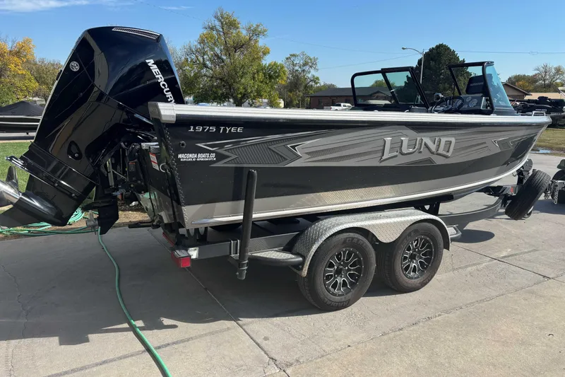 Slide: The Image of 2021 Lund 1975 Tyee boat on trailer, featuring Mercury outboard motor. - 3