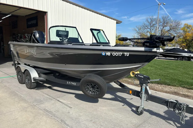 Slide: The Image of 2021 Lund 1975 Tyee boat on trailer, parked outside a building. - 4