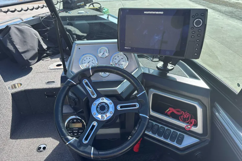Slide: The Image of Dashboard of a 2021 Lund 1975 Tyee boat with steering wheel and Humminbird Helix 10 display. - 5