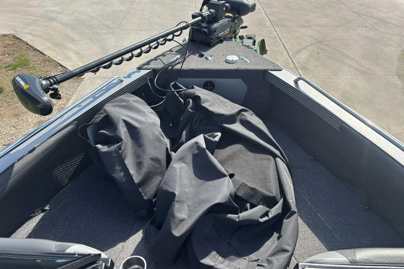 Slide: The Image of 2021 Lund 1975 Tyee boat interior with Minn Kota trolling motor and protective cover. - 6