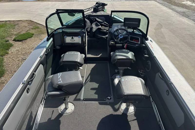 Slide: The Image of Interior of a 2021 Lund 1975 Tyee boat with seating and steering console. - 8