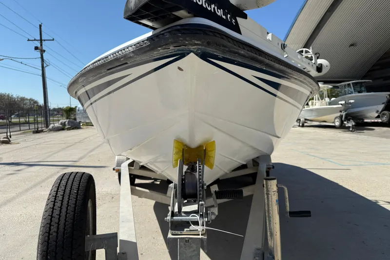 Slide: The Image of 2007 Champion 22 Bay Champ boat on trailer, parked outdoors under clear sky. - 3