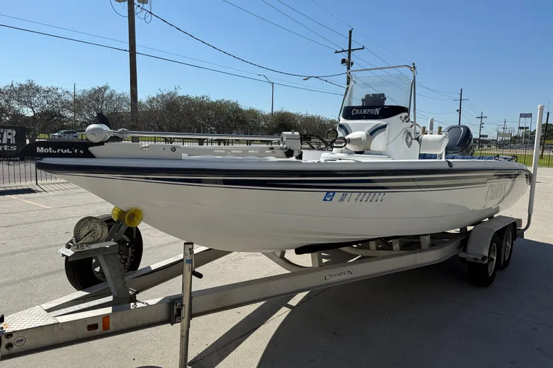 Slide: The Image of 2007 Champion 22 Bay Champ boat on trailer, parked outdoors. - 4