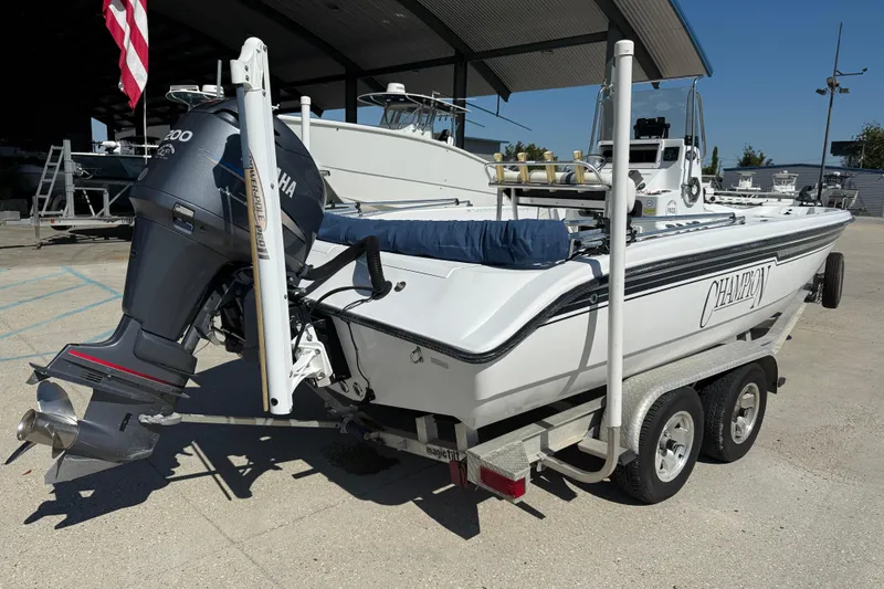 Slide: The Image of 2007 Champion 22 Bay Champ boat on trailer with Yamaha outboard motor. - 7