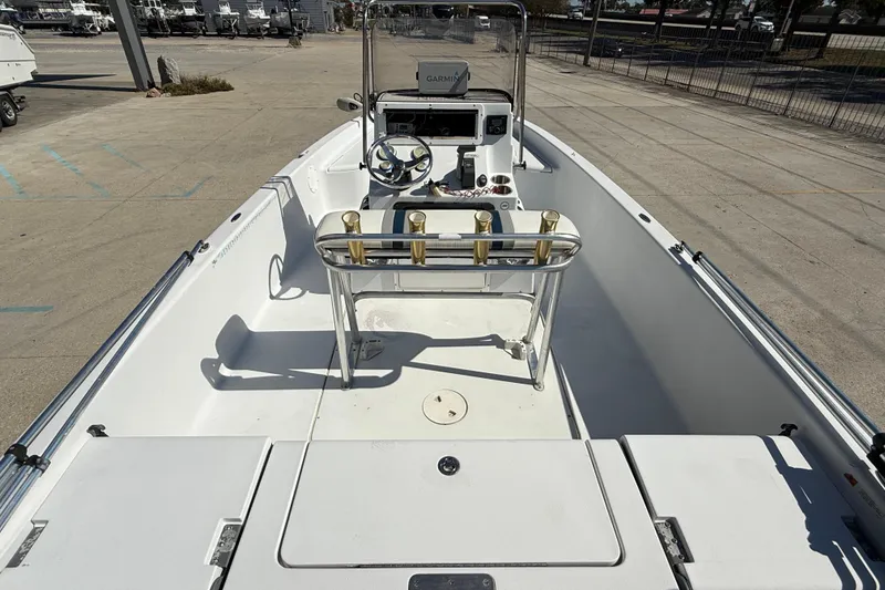 Slide: The Image of 2007 Champion 22 Bay Champ boat interior with steering console and rod holders. - 8