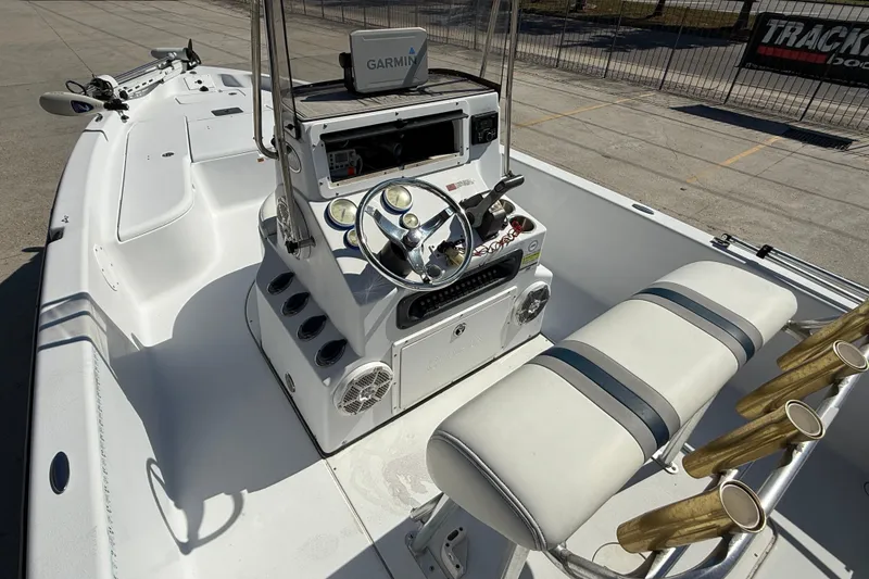 Slide: The Image of 2007 Champion 22 Bay Champ boat interior with Garmin navigation system and rod holders. - 9