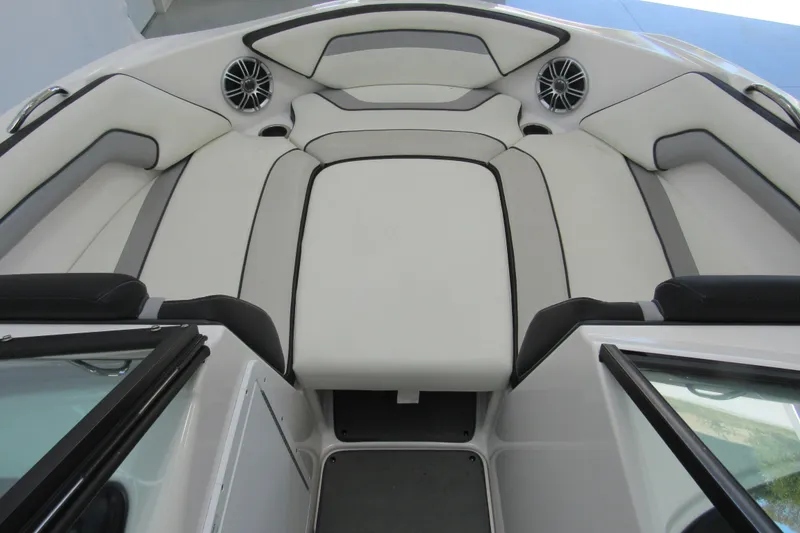 Slide: The Image of 2017 Yamaha Boats AR195 interior with white and gray seating, featuring built-in speakers. - 10