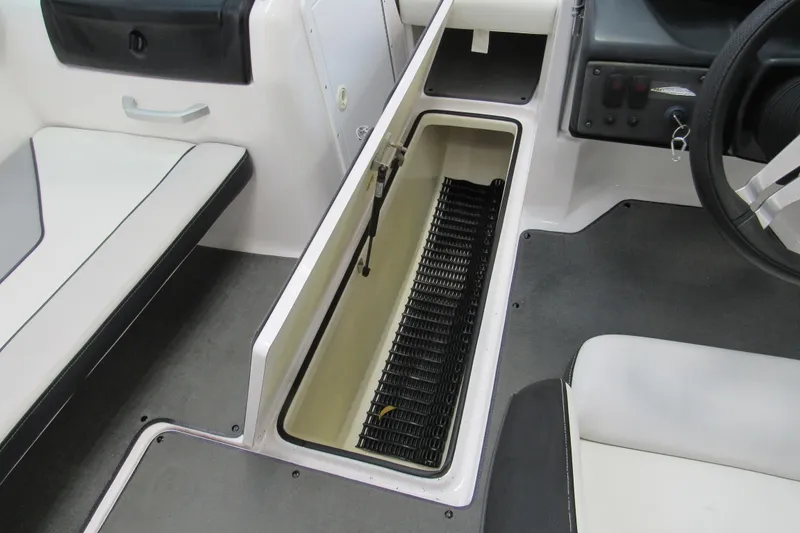 Slide: The Image of 2017 Yamaha Boats AR195 interior storage compartment with seating and steering wheel. - 11