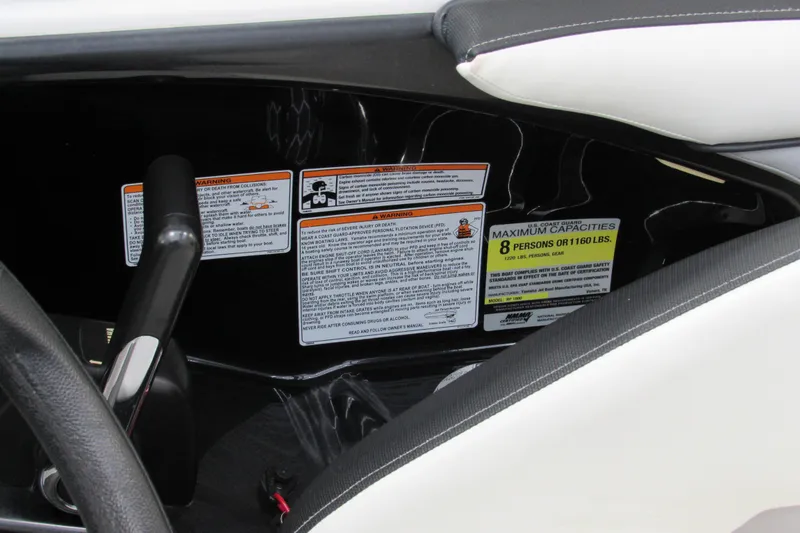 Slide: The Image of 2017 Yamaha Boats AR195 capacity and warning labels near steering area. - 12