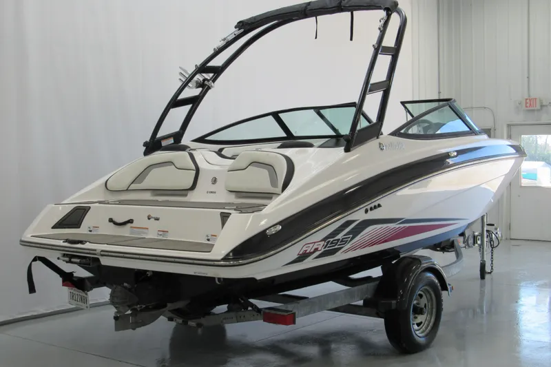 Slide: The Image of 2017 Yamaha Boats AR195 on trailer in indoor showroom, rear view. - 2