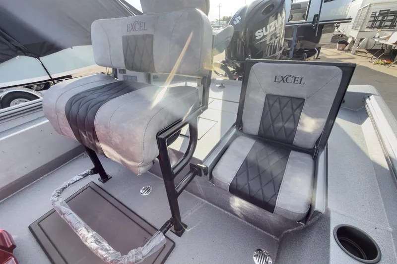 Slide: The Image of 2026 Excel Bay Pro Elite 220 boat seats with diamond-pattern upholstery and Suzuki motor in background. - 10