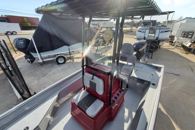 Slide: The Image of 2026 Excel Bay Pro Elite 220 boat with seating and console, parked outdoors. - 15