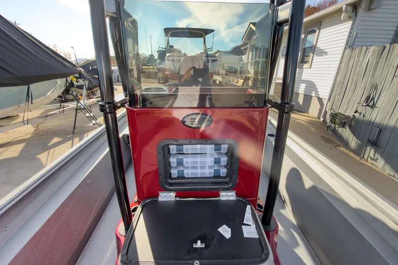 Slide: The Image of 2026 Excel Bay Pro Elite 220 boat console with storage compartment, docked outdoors. - 16