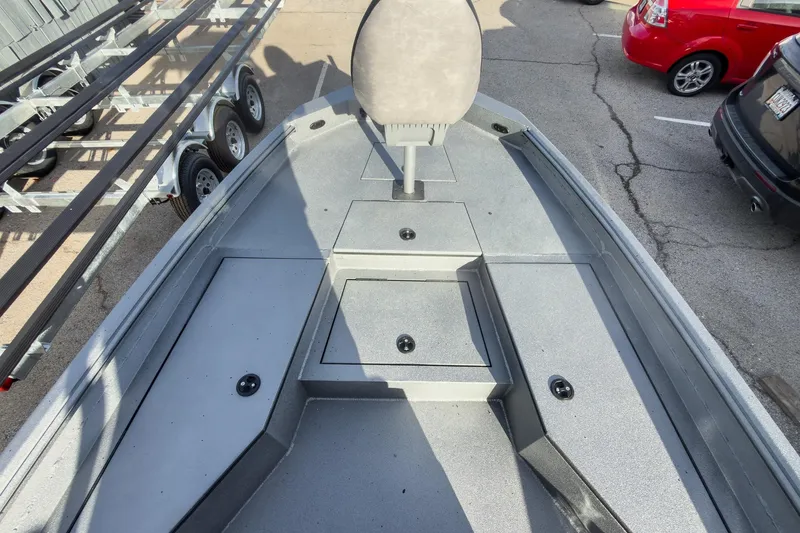 Slide: The Image of 2026 Excel Bay Pro Elite 220 boat interior with seating and storage compartments. - 17