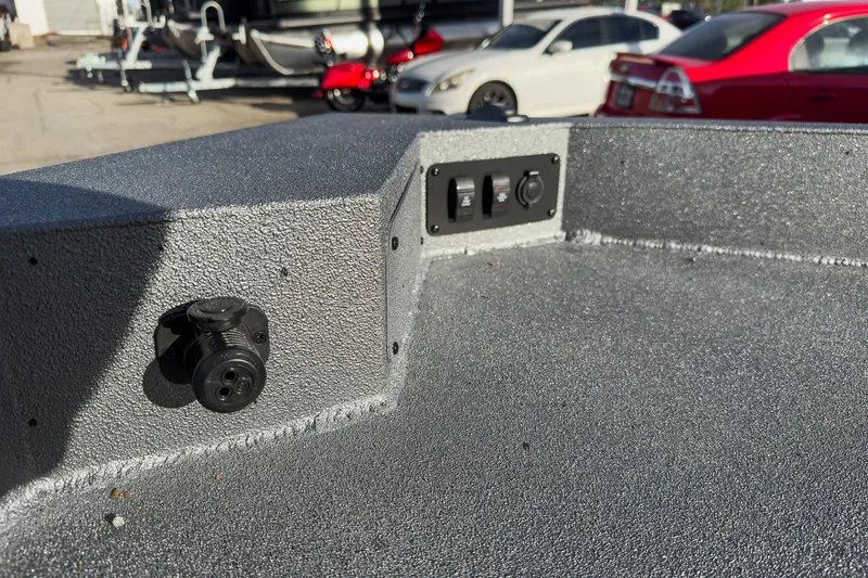 Slide: The Image of 2026 Excel Bay Pro Elite 220 boat interior with control panel and textured surface. - 19