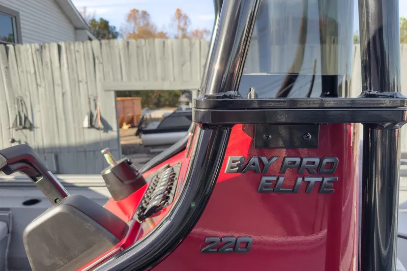 Slide: The Image of 2026 Excel Bay Pro Elite 220 boat console with red finish and black accents. - 21