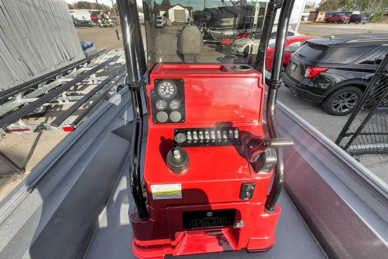 Slide: The Image of 2026 Excel Bay Pro Elite 220 boat console with red dashboard and control panel. - 24